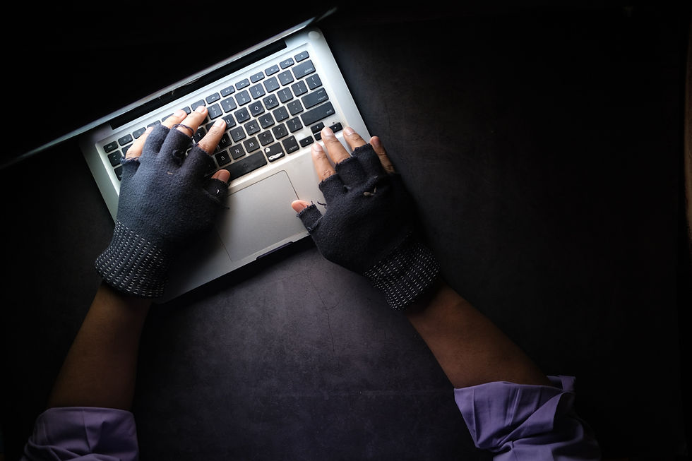 Gloved person using laptop