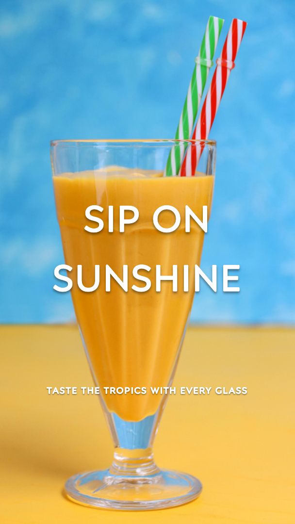 glass of orange juice with two straws